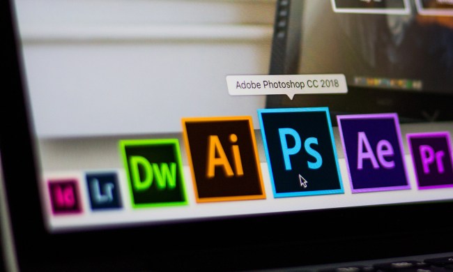 Close up of Adobe Photoshop app icon being chosen from among other Adobe apps on a laptop screen.