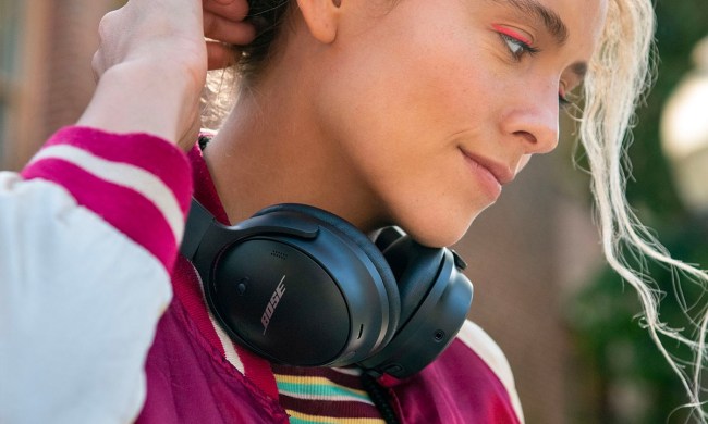 A woman wearing the Bose QuietComfort 45 around her neck.
