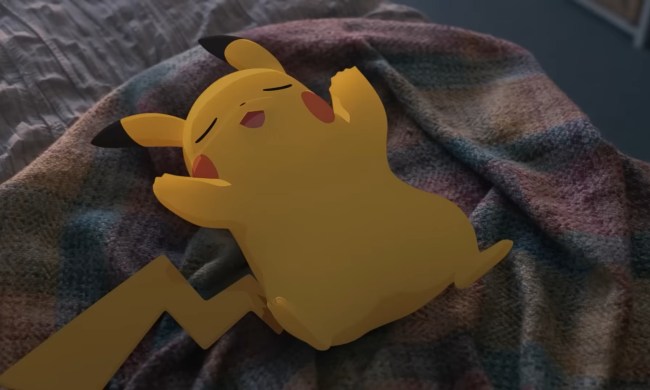 A Pikachu sleeps on a bed.